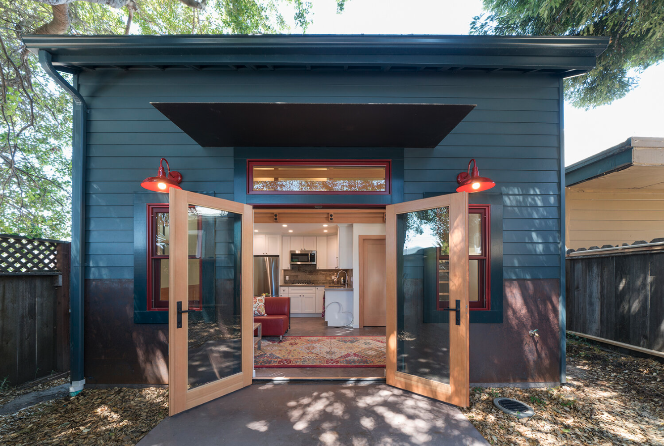 image of ADU, exterior navy blue with open french doors.